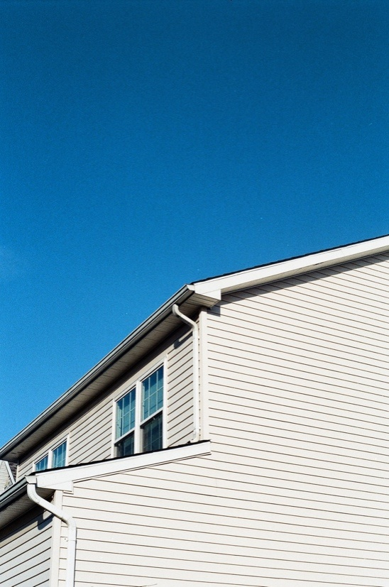 A Freshly Pressure Washed House Siding Against a Clear Blue Sky