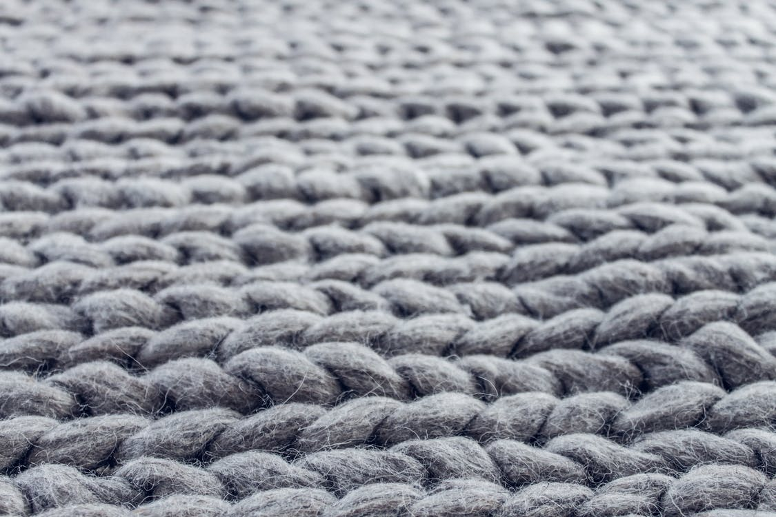 Close-up of a clean grey knit-cloth rug